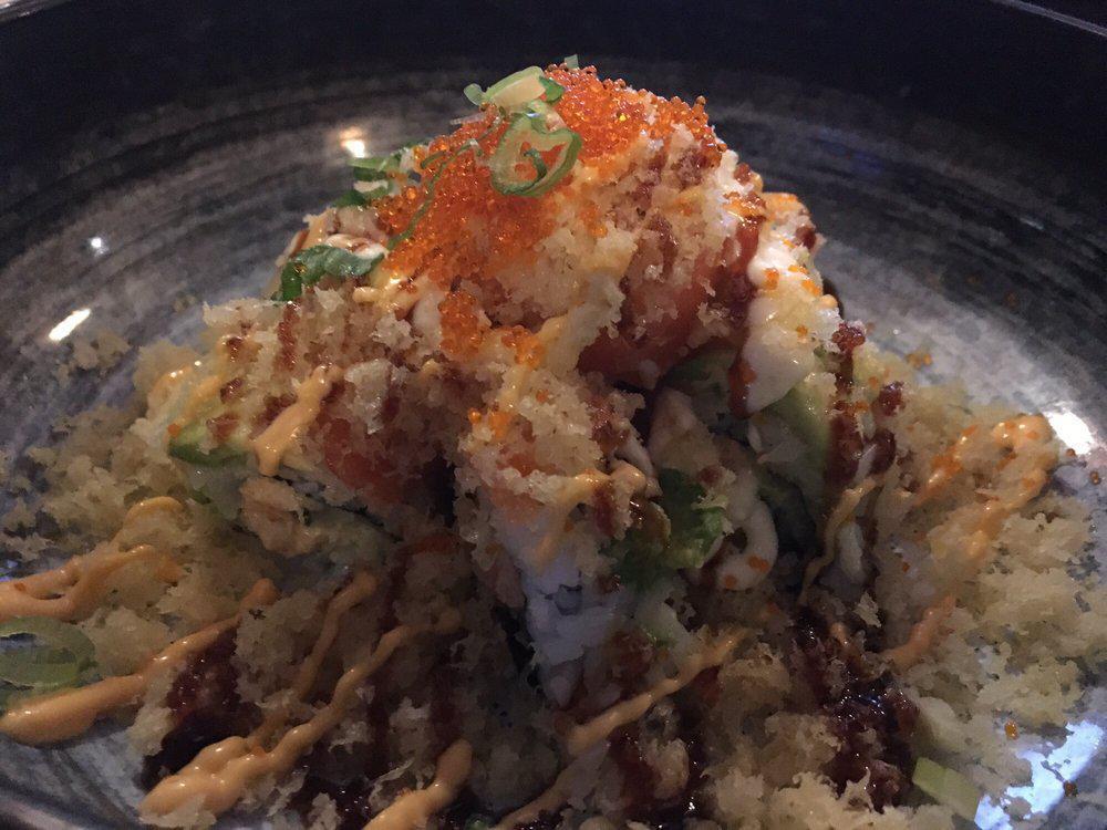 Crunchy Lobster Roll · Lobster salad, cucumber topped with salmon, avocado, crunchy flake, tobiko, green onion, special sauce.