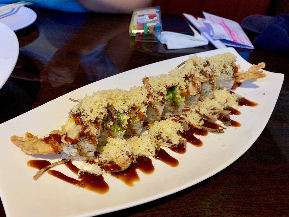Ninja Roll · Fried shrimp, spicy tuna, cucumber topped with albacore tuna, fried onion, tempura flakes, ponzu, eel sauce, and avocado. Spicy.