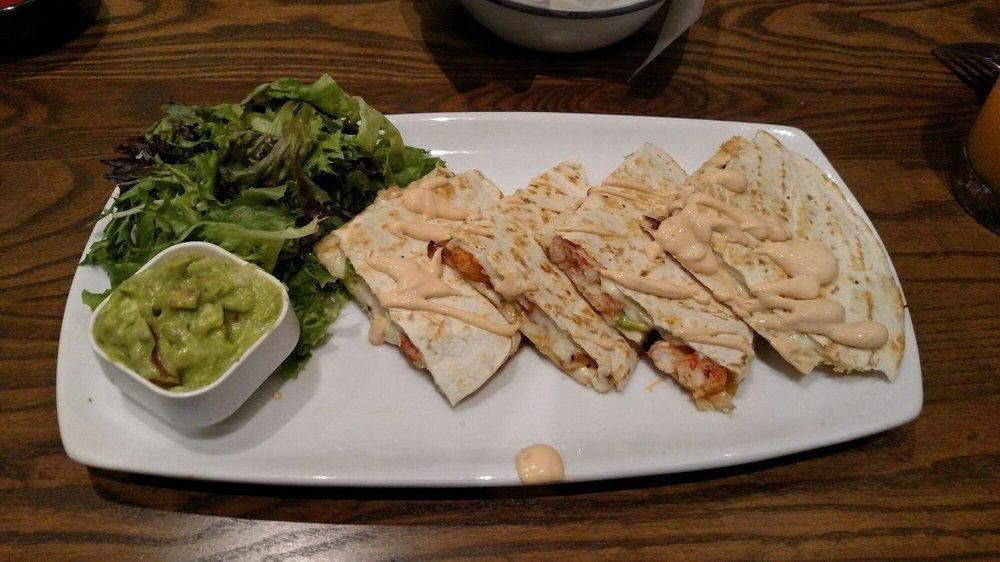Quesadillas · Large flour tortilla with 3 varieties of melted cheese, sour cream, salsa and guacamole.