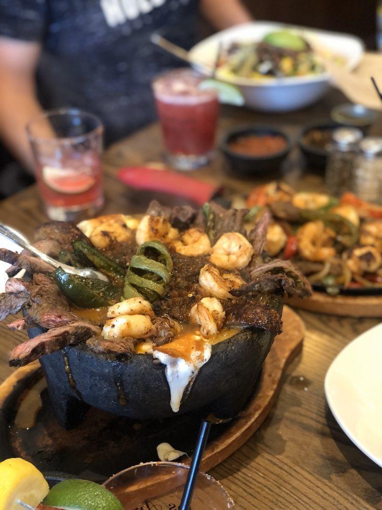 Molcajete · Arroyo molcajete chicken or steak served with roasted salsa, grilled chorizo, grilled nopales, Mexican onion, queso panela and served with choice of tortillas.
