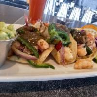 Tacos Gobernador · Shrimp tacos sauteed with papilla Chile and Oaxaca cheese, served with homemade chunky guaca...