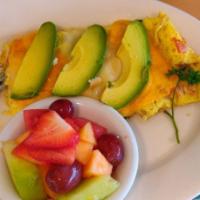 Veggie Omelette · Sautéed mushrooms, onions, bell peppers, tomatoes, spinach ​and avocado. Topped with cheddar...