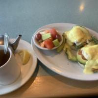 California Benedict · Two poached eggs on an english muffin, paired with bacon, avocado, and tomato, topped with h...