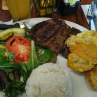 Carne Asada · Grilled beef steak. With rice, salad, and sweet plantains.
