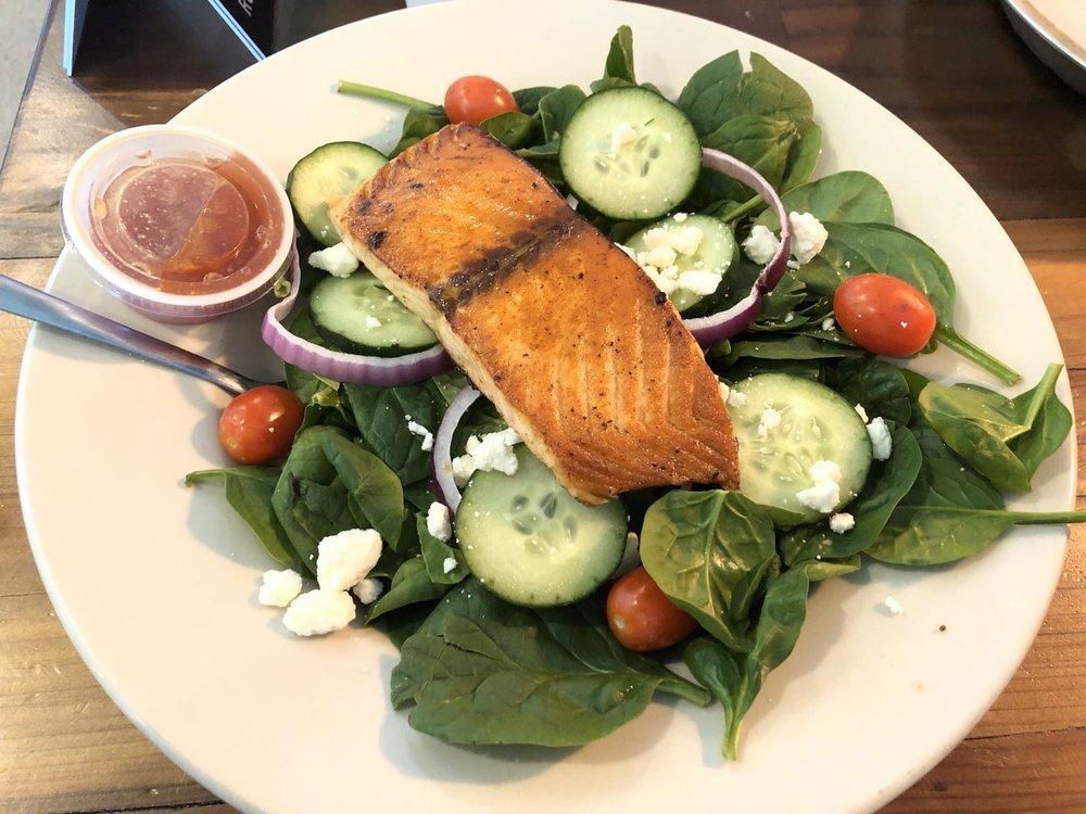Spinach Salmon Salad · Grilled Atlantic salmon fillet on bed of fresh spinach, cherry tomatoes, red onion, cucumbers and feta cheese. Served with balsamic vinaigrette.