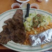 Carne Asada · Steak served with rice and beans.