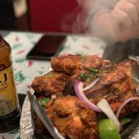 Tandoori Chicken · Chicken marinated in yogurt, mild spices and herbs and cooked in tandoor clay oven.