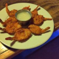 Coconut Shrimp · 8 pieces. Jumbo Shrimp in a Coconut Batter Accompanied by a Pina Colada Dip.
