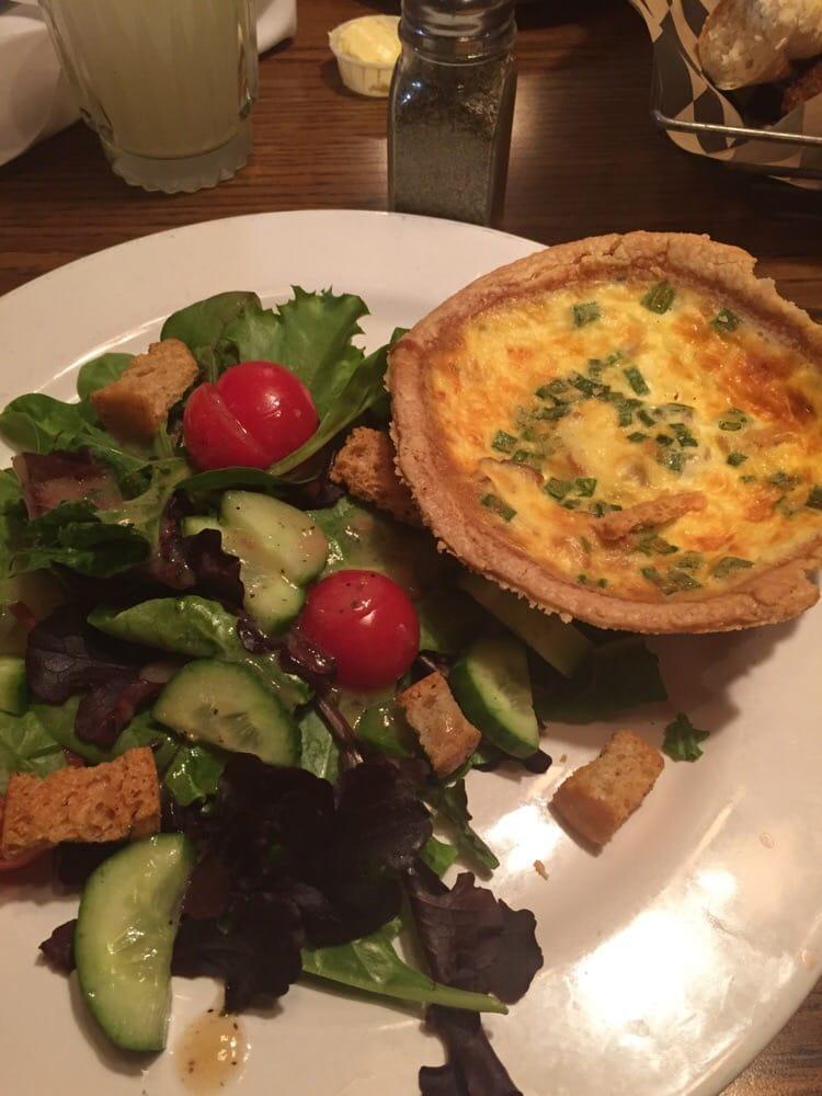 Quiche Lorraine · Housemade with hickory-smoked bacon, green onion, mozzarella and aged parmesan. Served with roasted potatoes.