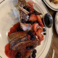 Pain Perdu with Mixed Berries · Stuffed brioche french toast filled with orange marmalade and cream cheese blend topped with...