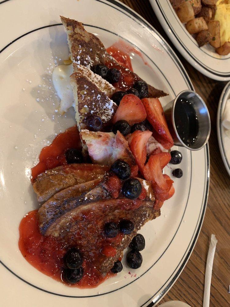 Pain Perdu with Mixed Berries · Stuffed brioche french toast filled with orange marmalade and cream cheese blend topped with fresh berries and strawberry purée. 