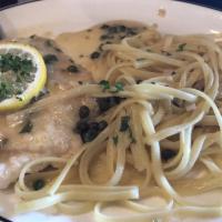 Chicken Piccata · Tender breast of chicken sauteed in lemon butter, white wine and capers, served with spaghet...