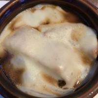 French Onion Soup · Homemade beef stock infused with caramelized onions, topped with garlic croutons and melted ...