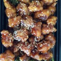 Sesame Chicken · Cubes of chicken cooked with sesame seed on a bed of broccoli. Served with white rice. 