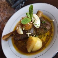 Lamb Shank · Braised lamb shank in chef’s Moroccan spices and herbs, with apricots and raisins. Served wi...