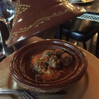 Kefta Mkaouara · Beef and lamb meatballs in a spiced tomato sauce, topped with poached eggs with pita. Dairy ...