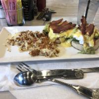 Eggs Benedict · 2 poached eggs with Canadian bacon on a toasted English muffin and topped with our hollandai...