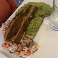 Tartine Club Sandwich · Open faced toasted rye bread with vegan chicken (pea protein), avocado puree, tomatoes, vega...