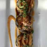 Who Dat Roll · Tempura fried spicy salmon, avocado, and crunchy flakes topped with scallions, roasted garli...