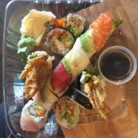 Rainbow Roll · Kanikama, masago, avocado and cucumber topped with tuna, salmon, escolar, yellowtail and avo...