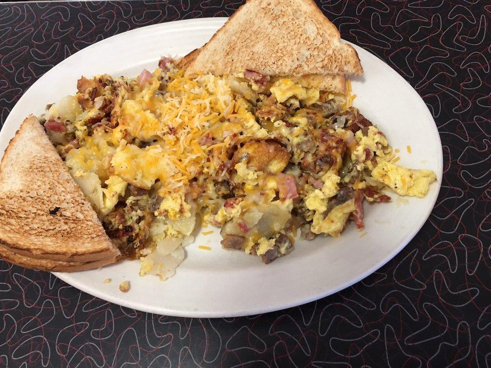 Meat Lovers Skillet · Bacon, ham, sausage, onions, green peppers and scrambled eggs mixed with home fries and topped with shredded cheddar and mozzarella mix.