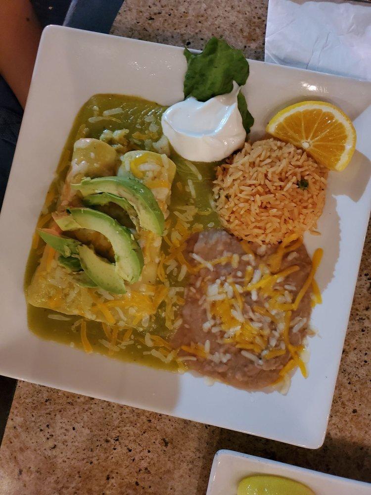 Shrimp and Crab Enchiladas · Two corn tortillas stuffed with shrimp, crab, cheese, bell pepper, and onion. Topped with creamy green sauce, cheese and avocado slices. Served with rice and beans.