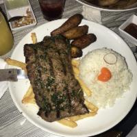 Churrasco a Lo Pobre · Grill churrasco served with rice, fries, sweet plantains and eggs and anticuchera sauce.