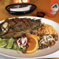 Mojarra Frita · Deep fried whole tilapia. Served with rice, french fries and a fresh salad.