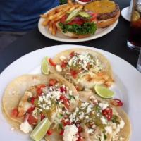 Fish Tacos · Grilled Cod fish with VeraCruz cole slaw, cotija queso fresco, on corn tortillas served with...