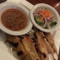 Satay · Chicken skewers served with peanut sauce and cucumber salad.