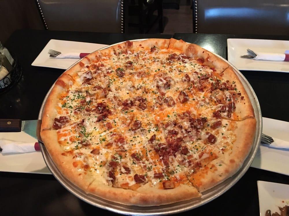 Chicken Bacon Ranch Pizza · Fried chicken cutlet, bacon, cheddar cheese, topped with ranch dressing. Round deep dish crust is available for an additional charge. 