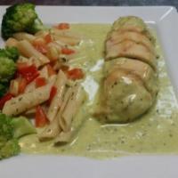 Chicken Pesto Genovese · Baked chicken breast stuffed with spinach and mozzarella cheese drizzled with our creamy pes...