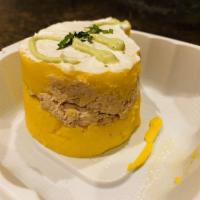 Causa · Two layers of whipped yellow potatoes made with aji amarillo chili, served with a tasty laye...