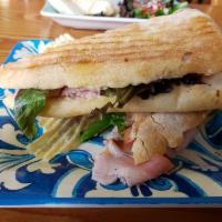 Rome Panini · Porchetta (roasted pork), tomatoes, baby spinach and provolone cheese.