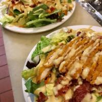Crispy Chicken Salad · Chopped breaded chicken, romaine lettuce, green peppers, onions, carrots, tomatoes bacon and...