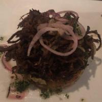 Vaca Frita · Shredded fried beef with onions, served with maduros and moro rice