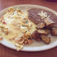 Migas · 2 scrambled eggs with tortilla chips and pico de gallo, topped with melted cheese, served wi...