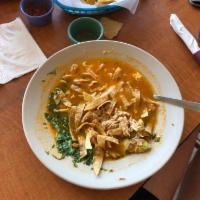 Tortilla Soup · Served with fried corn tortillas, chicken, avocado, cilantro and melted cheese. Servida con ...