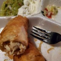 Chicken Taquitos · Fried flour tortilla with chicken, served over a bed of lettuce with guacamole and sour cream.