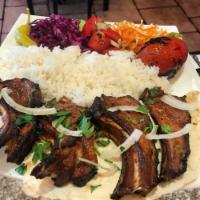 Lamb Chops BBQ · Grilled lamb chops served  with white basmati rice, salad and grilled tomato