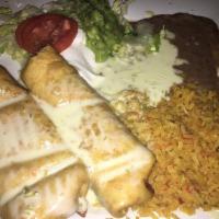 Chimichanga · Soft or deep fried burrito. Served with cheese sauce on top. Served with sour cream, tomato,...