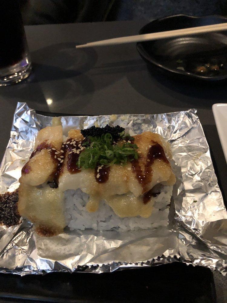 Raiders Roll · Baked scallop with garlic cream sauce on top of a California roll with tobiko. 