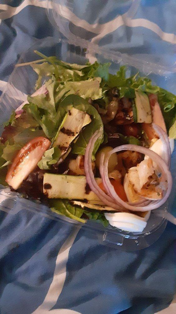 Greek Salad · Romaine lettuce, tomatoes, Kalamata olives, fresh feta cheese, stuffed grape leaves, and red onions.