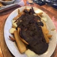 Poutine · A shareable portion of our steak fries topped with Yancey’s fancy local cheese curds and smo...