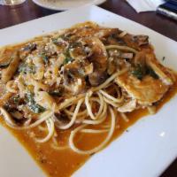 Chicken Marsala · Chicken breast sauteed with mushrooms, shallots and spinach on Marsala wine sauce over spagh...