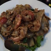 Kee Mao Goong Gai · Drunken noodles. Wide rice noodles stir-fried with onions, tomatoes, basil, shrimp and chick...