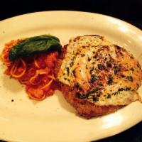 Veal Parmigiana · Breaded veal topped with tomato sauce and melted mozzarella served with side of spaghetti in...