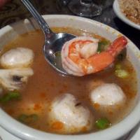 Tom Yum Goong Soup · The Thai national soup. Plump shrimp float in a clear lemony broth featuring fresh mushrooms...