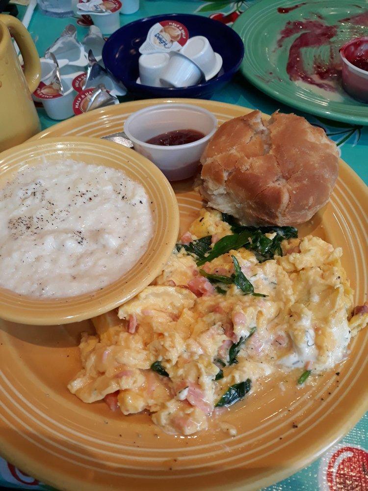 Smoked Salmon Scramble · Three eggs scrambled with chopped wood-smoked salmon and dill cream cheese, served with a choice of side and a fluffy flying biscuit with cranberry apple butter.