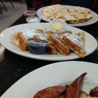 French Toast · Served with whipped butter and maple syrup. Add strawberry topping and whip cream for an add...